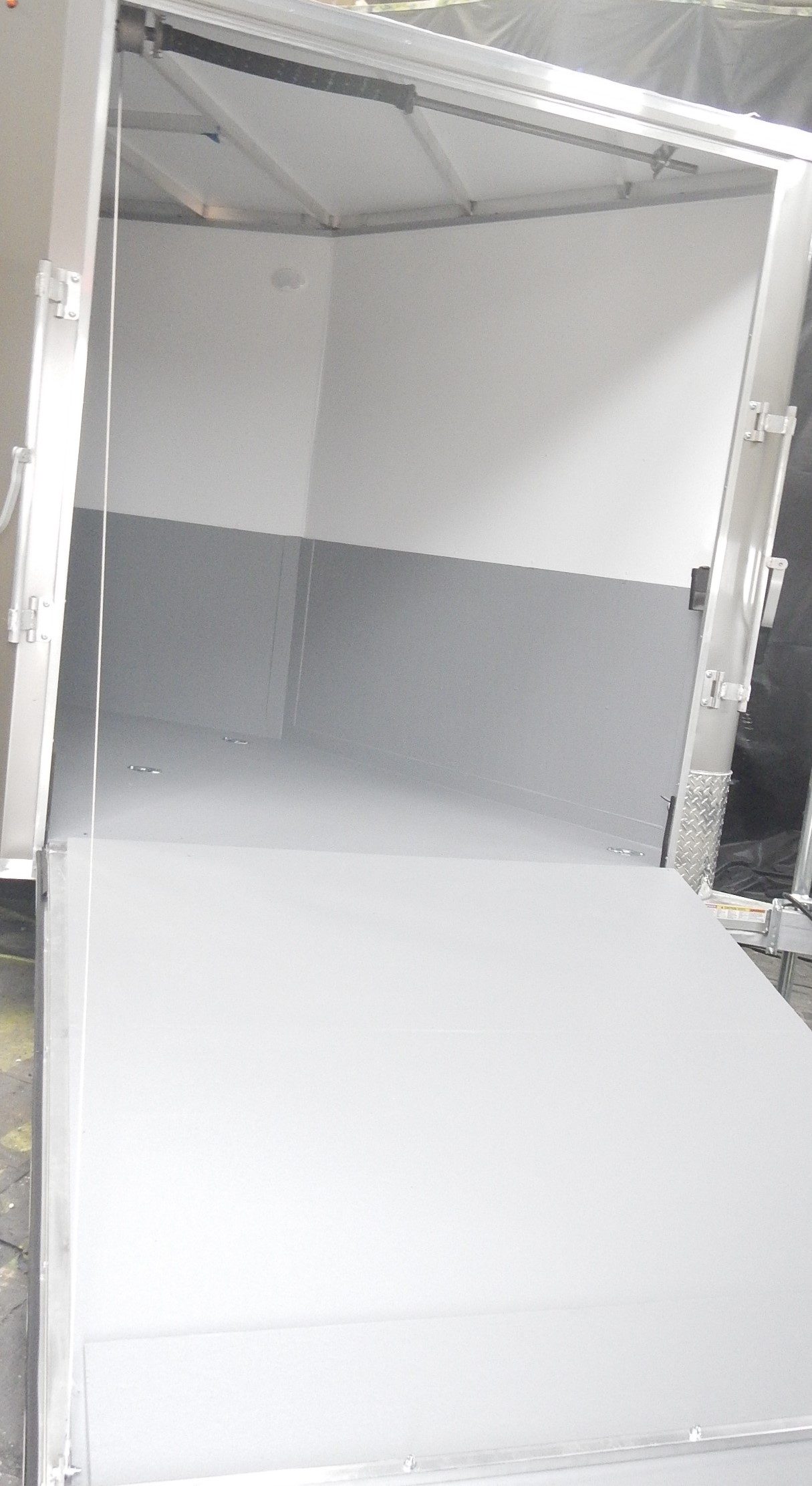 Open frame utility trailer underbody coating